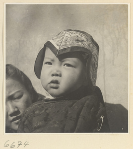 Woman and child wearing an embroidered hat