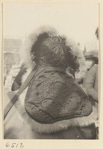 Man wearing a quilted, fur-lined hat