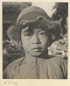 Boy wearing a fur-lined Mongolian hat