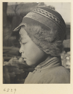 Boy wearing a fur-lined Mongolian hat