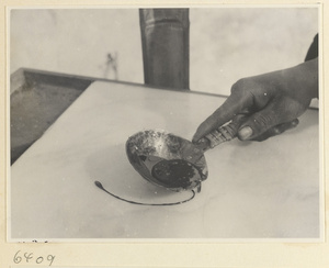 Tracery candy vendor pouring candy onto a marble slab