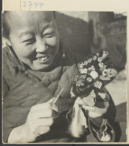 Woman with tweezers making a chenille souvenir