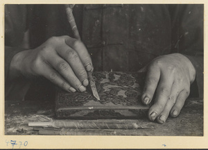 Boy carving lacquer in a workshop