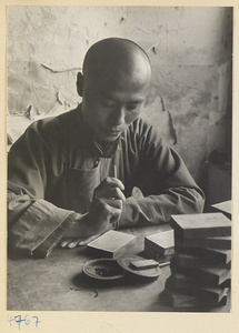 Man carving lacquer in a workshop