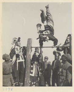 Soldiers dressed in costume performing gymnastic feats at New Year's