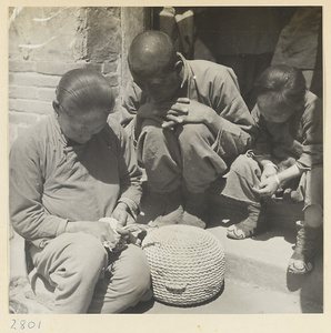 Woman making a maize straw cushion