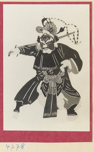 Paper-cut of a general with a sword wearing a headdress with tail feathers of a Reeves pheasant