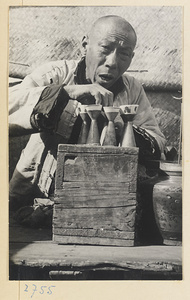 Street vendor selling liquor called bai gan made from sorghum grain