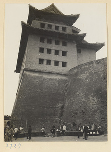 Vendors' stands at the foot of a city gate