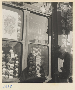 Shop window with a picture of a door god during New Year's