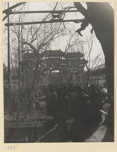 People in the street near a pai lou at New Year's