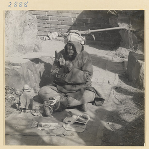 Man collecting alms at a temple festival at New Year's