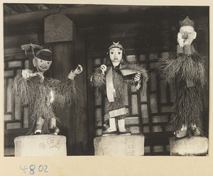 Three figures in an ice lantern shop