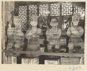 Four ice lanterns sculpted in the form of human figures