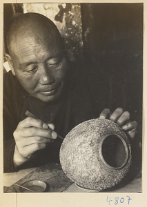 Man making a cloisonné bowl