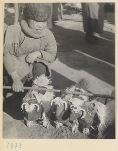 Child holding a pole with toy oxen at New Year's