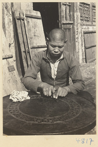 Furniture-maker working on an inlaid table, Furniture Street, Peking