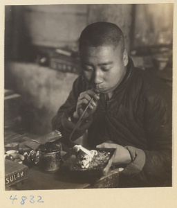 Silversmith working on a piece of heated silver in a workshop