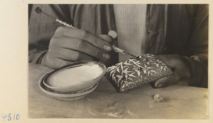 Man making a cloisonné lid