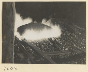 Metal being heated in a forge in a wheel-making shop