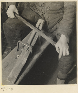 Blacksmith's assistant at work in a shop