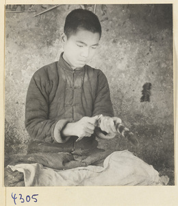 Man preparing fur in a brush-making shop