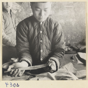 Man at work in a brush-making shop