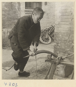 Man making a bow in a bow-and-arrow-making shop