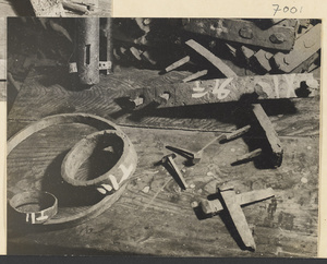 Work bench with tools and parts for making wooden cart wheels at a wheel-making shop