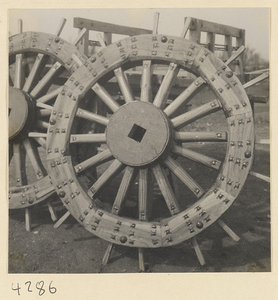 Wooden cart wheels outside a wheel-making shop