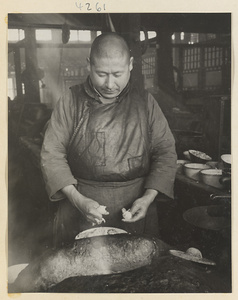 Restaurant interior showing a chef working with dough to make oil cakes