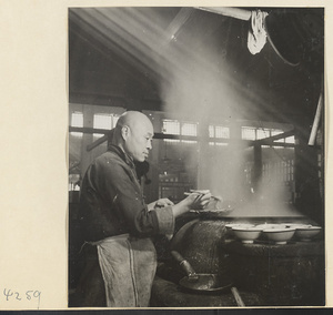 Restaurant interior showing a chef cooking noodles