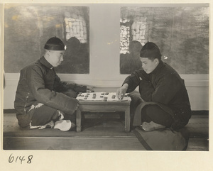 Two men playing chess at home