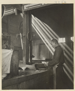 Restaurant interior showing a man working in a kitchen