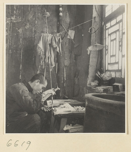 Man finishing a comb in a horn-comb workshop