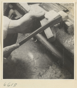 Man burnishing the teeth of a comb in a horn-comb workshop