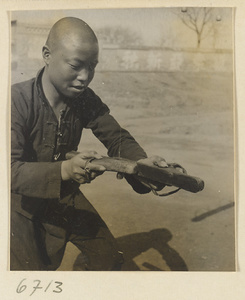 Silk spinner displaying his tools