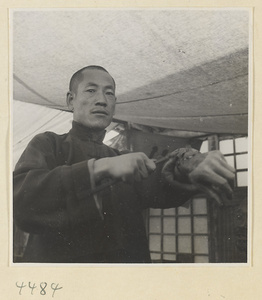 Street doctor's stand showing a patient with a poultice on his hand