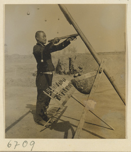 Boy spinning silk outdoors