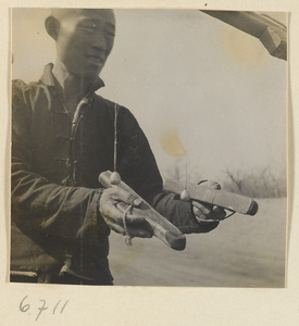 Silk spinner displaying his tools