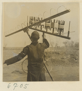 Boy spinning silk outdoors