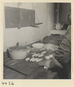 Kitchen of Niu Rou Wan, a Muslim grilled-beef restaurant, showing a chef dividing dough into pieces