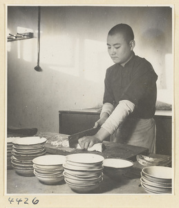 Kitchen of Niu Rou Wan, a Muslim grilled-beef restaurant, showing a man chopping food