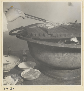 Kitchen of Niu Rou Wan, a Muslim grilled-beef restaurant, showing a chef stirring food on a grill