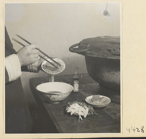 Kitchen of Niu Rou Wan, a Muslim grilled-beef restaurant, showing a chef adding beef to a marinade