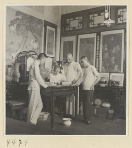 Mr. Huang in his antique shop with his staff