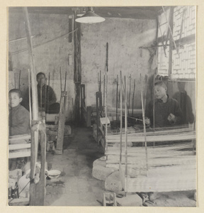 Men spinning silk in a workshop