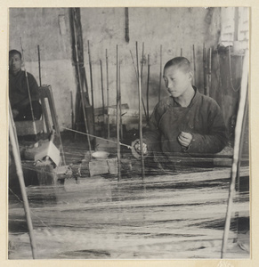 Men spinning silk in a workshop