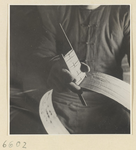 Man making a rim for a bamboo steamer in a workshop