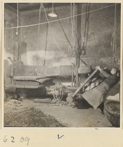 Tobacco shop interior showing a man operating a tobacco press